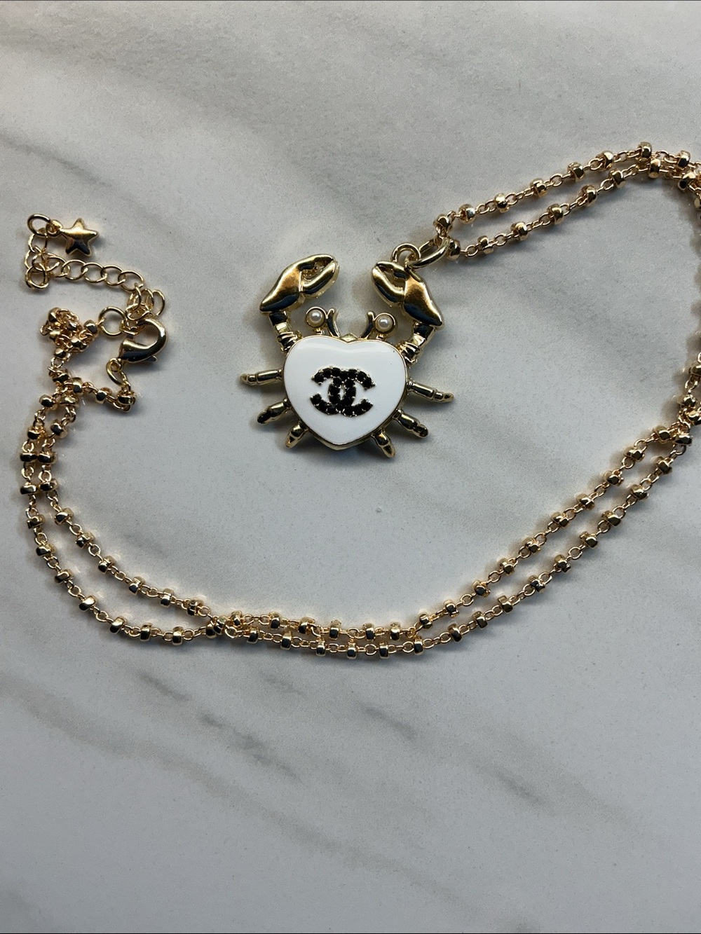 Gold-Tone Crab Pendant Necklace with White Enamel Heart and Black Logo - Picture 7 of 7